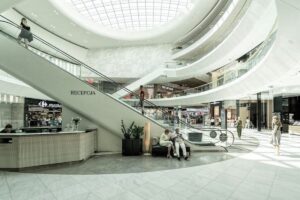 Boże Ciało 2025 sklepy - co jest otwarte? Na zdjęciu korytarz centrum handlowego i duże schody ruchome.