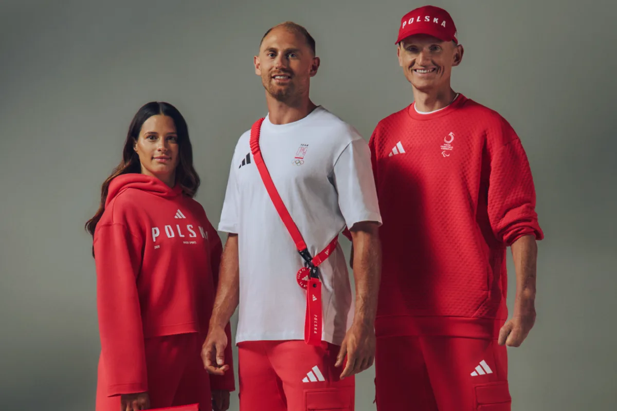 Stroje Polaków na Zimowe Igrzyska Olimpijskie 2026 – jak wyglądają? Kobieta i dwóch mężczyzn w czerwono-białych strojach sportowych, jeden z nich w białej koszulce i czerwonych spodniach.