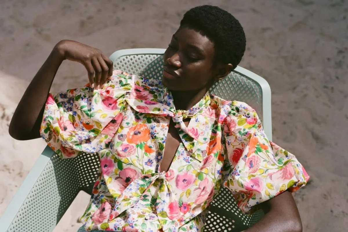 Marki najszybciej zyskujące na znaczeniu Lyst Index Q1 2026. Modelka w kwiecistej bluzce Zara w letniej stylizacji inspirowanej estetyką lat 90. Marka znalazła się wśród najszybciej zyskujących na znaczeniu według Lyst Index Q1 2026, budując uwagę poprzez obecność w kulturze i trendach.